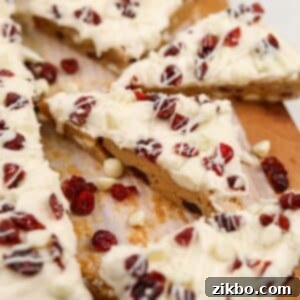 Heavenly Cranberry Bars 12 A triangular cranberry bliss bar topped with dried cranberries and cream cheese frosting.
