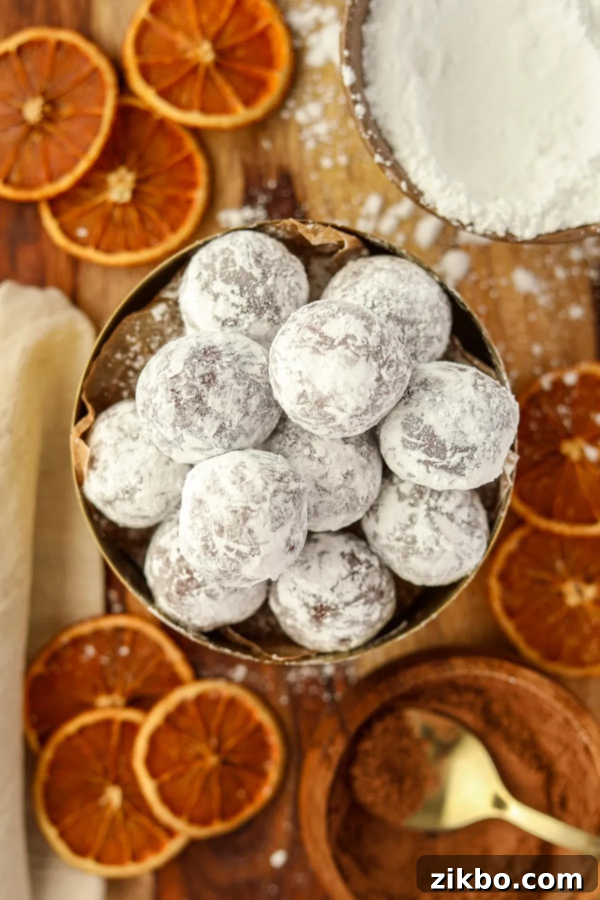 A beautifully arranged bowl of chocolate truffles coated in powdered sugar, ready to be served or gifted.