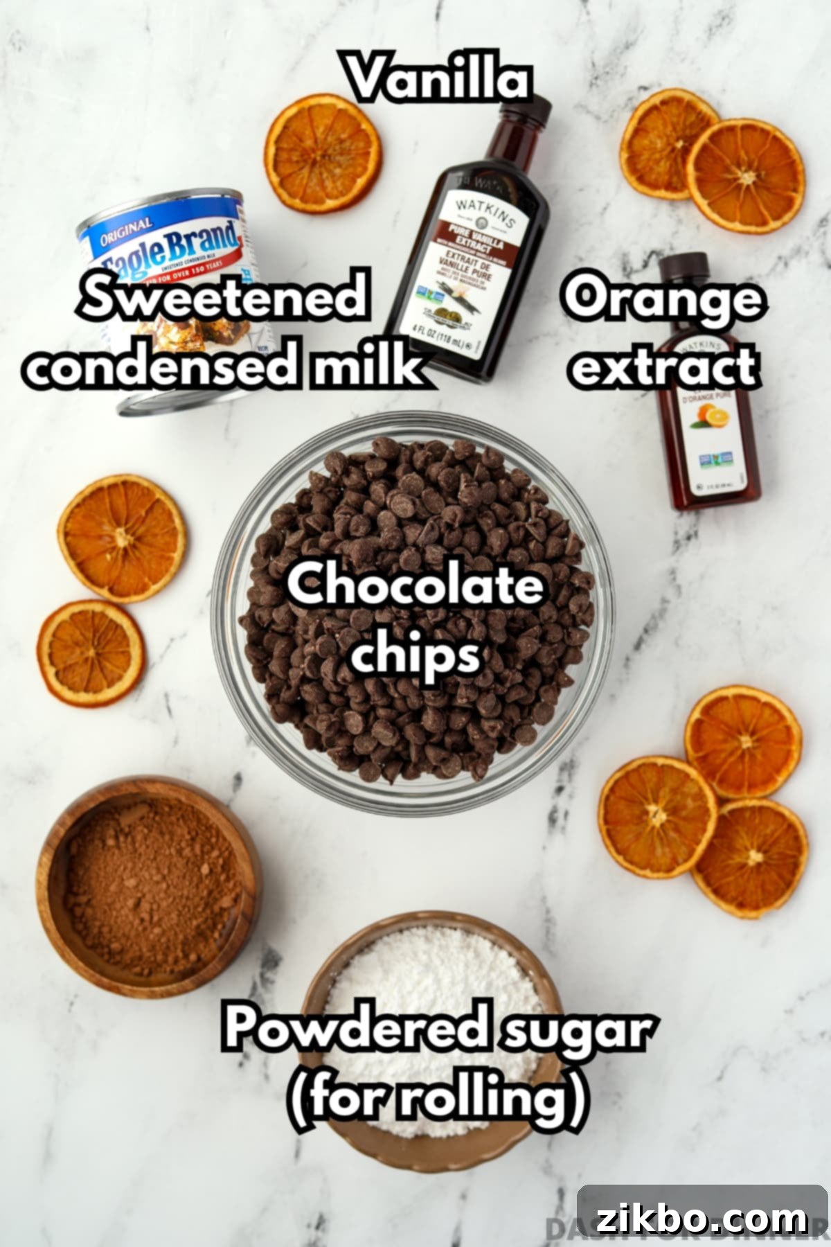 All the essential ingredients neatly arranged for making easy orange truffles: a can of sweetened condensed milk, chocolate chips, orange extract, and vanilla extract.