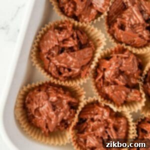 Muffin liners filled with chocolate potato chip clusters, a perfect no-bake dessert.