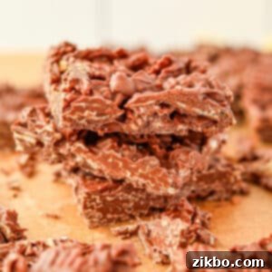 A stack of three pieces of chocolate bark, featuring wavy potato chips.