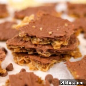 A stack of perfectly prepared potato chip toffee pieces, topped with a thin, smooth layer of melted chocolate, ready to be served.