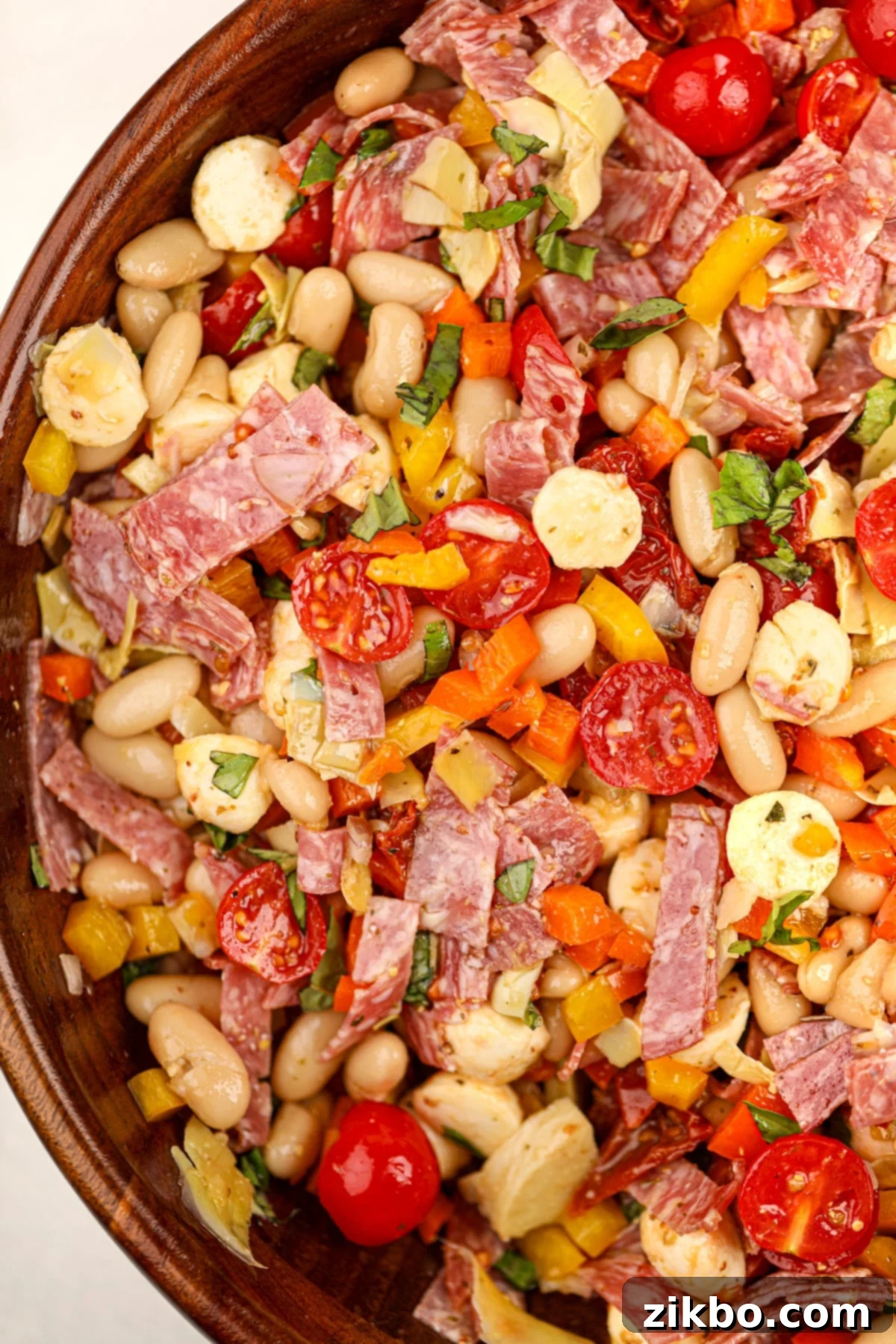 Classic Italian Bean Salad 7 A wooden bowl filled with a colorful bean salad.