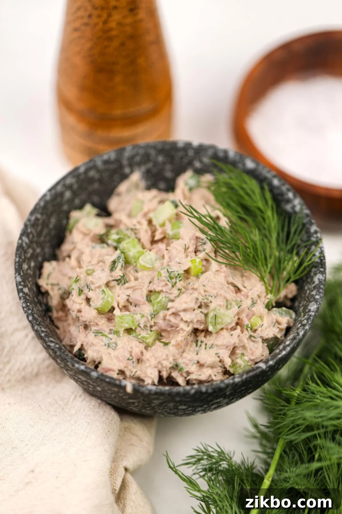 Bright Dill Tuna Salad 5 A small bowl of creamy tuna salad, generously garnished with fresh dill sprigs, ready to be served as a delightful lunch or snack.
