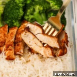 A fork with two slices of juicy chicken breast.