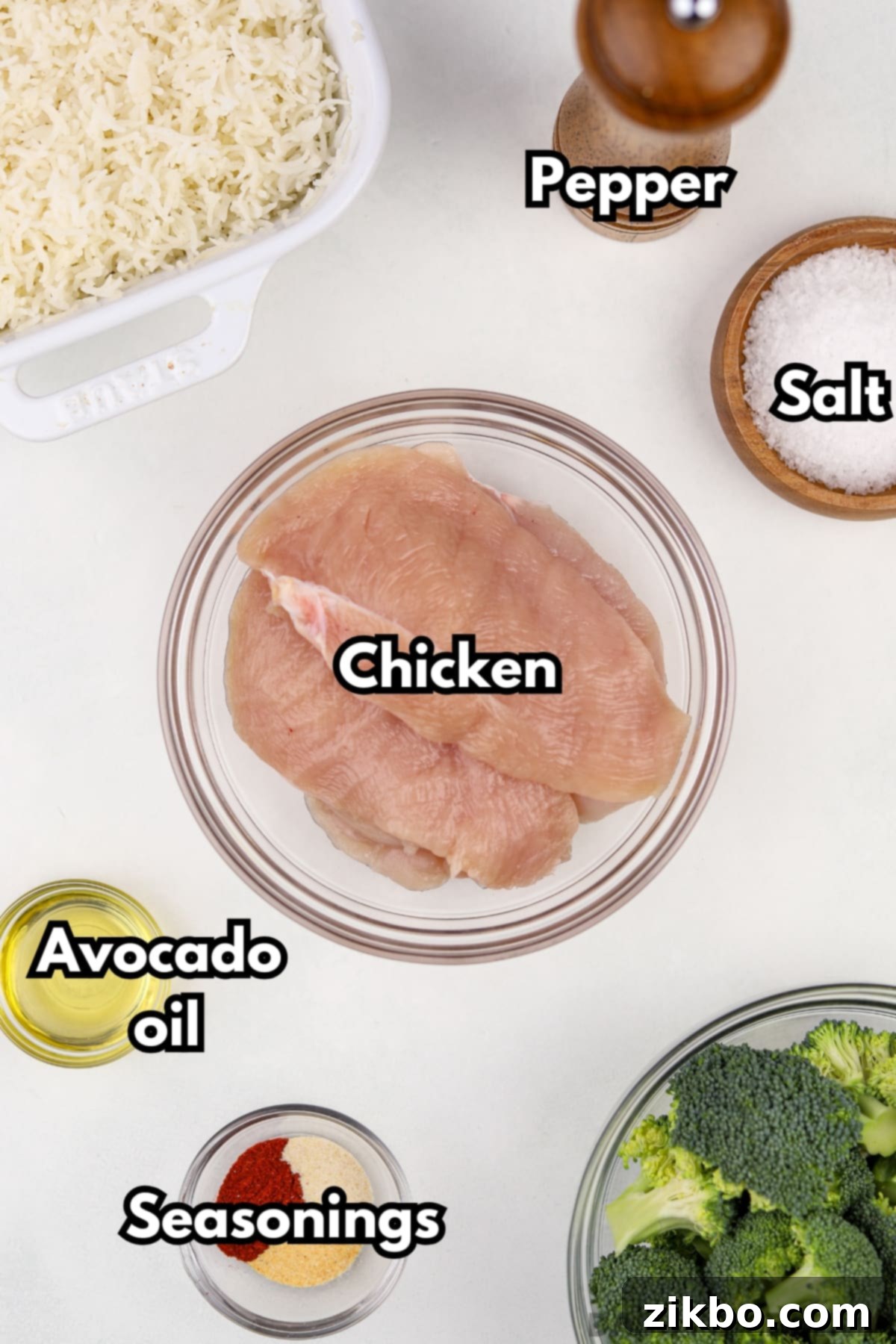 A bowl of chicken cutlets, and small bowls of seasoning and oil.