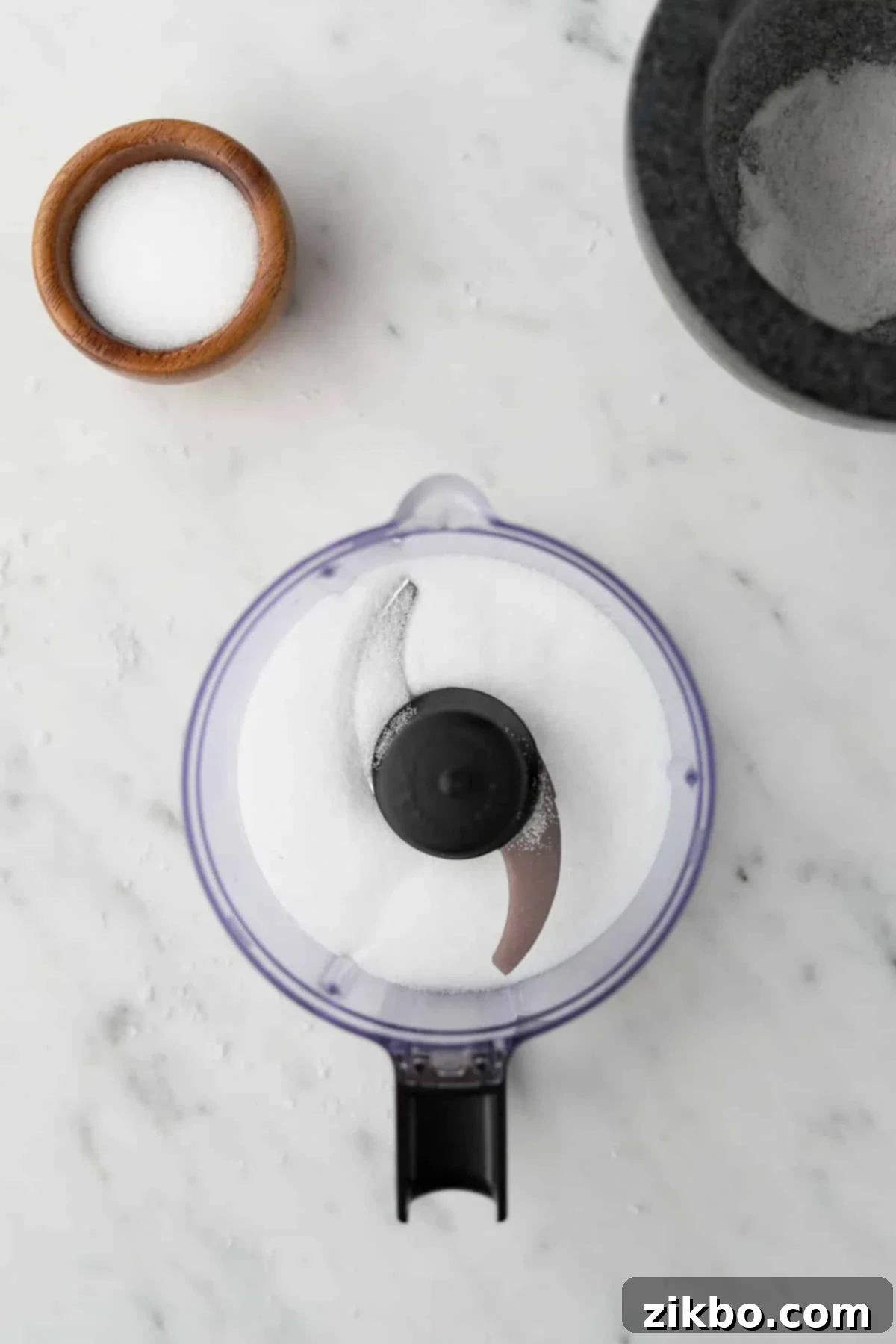 A small food processor filled part way with salt.