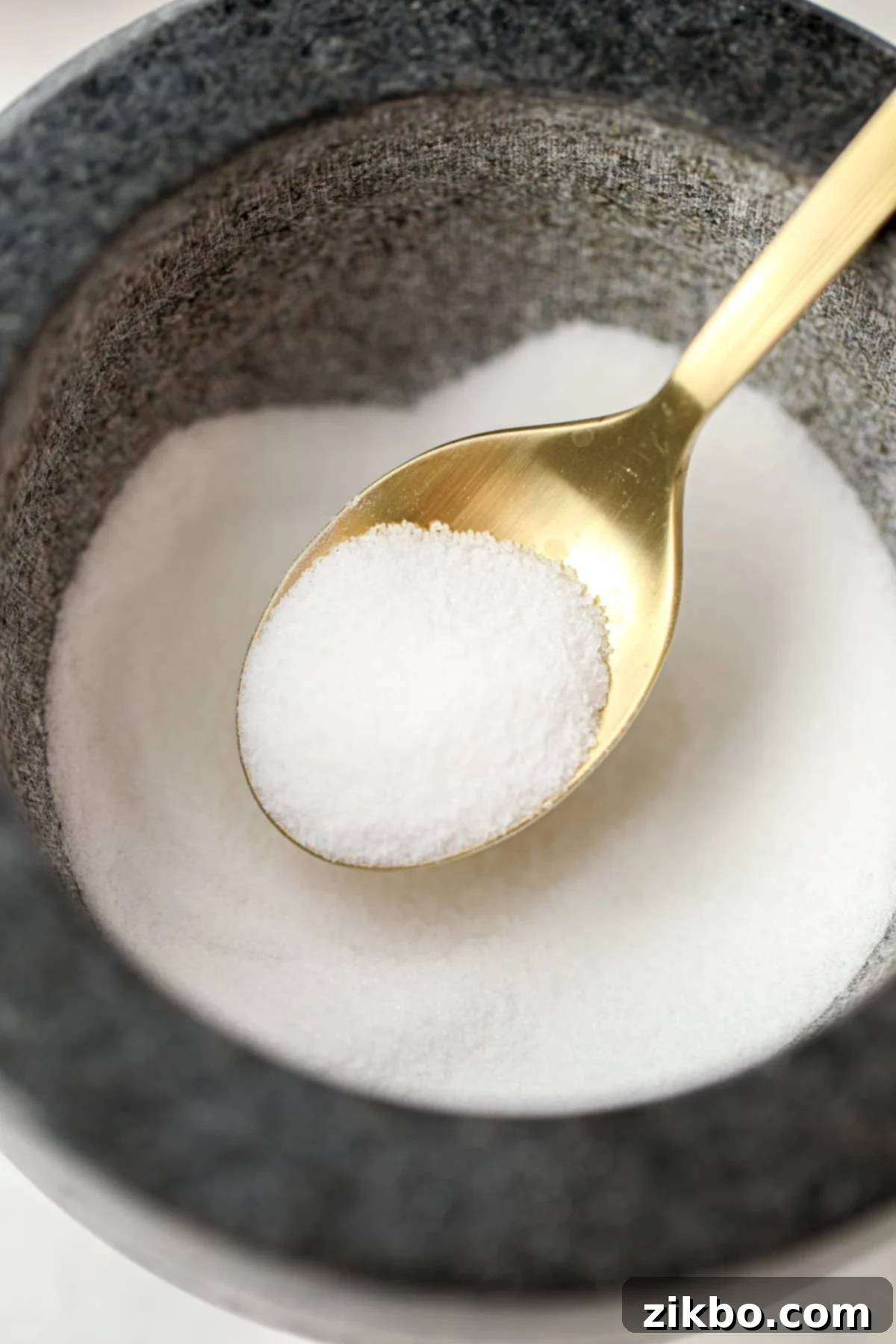 Scooping salt from a mortar bowl.