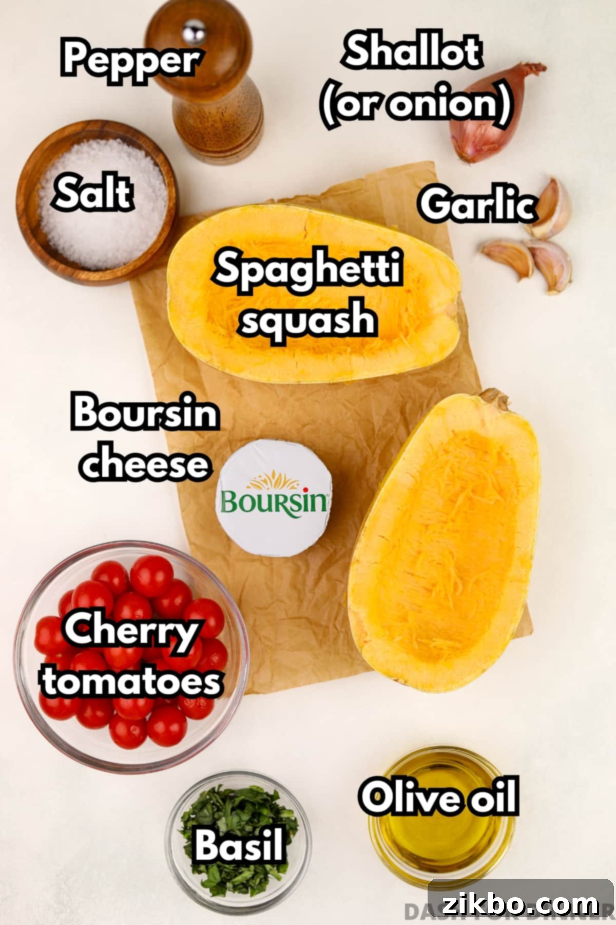 A beautiful flat lay of fresh ingredients required for Boursin Stuffed Spaghetti Squash: vibrant cherry tomatoes, fragrant basil, rich olive oil, whole garlic cloves, salt, and pepper.