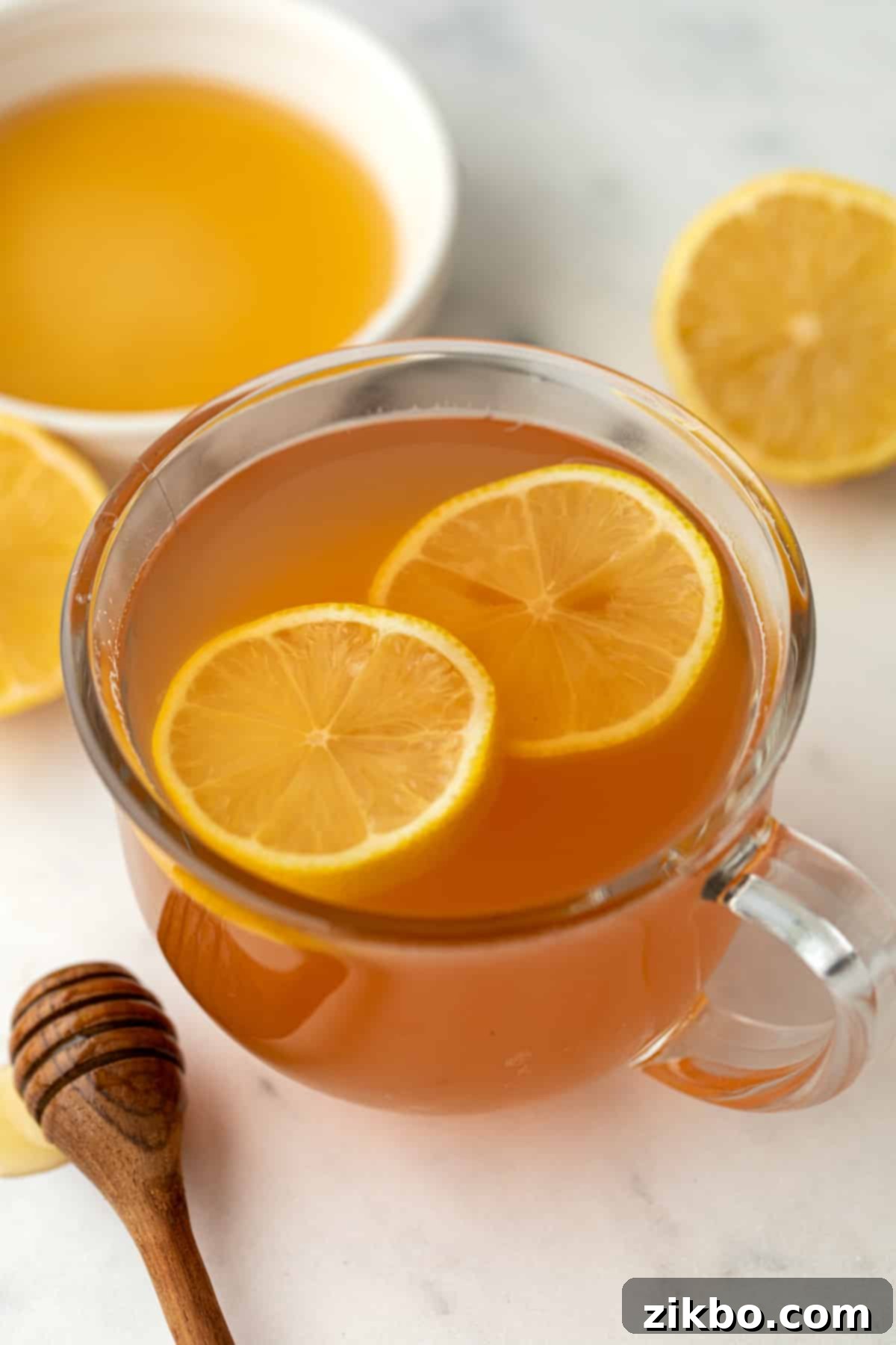 A mug of tea garnished with slices of fresh lemon, ready to be enjoyed.