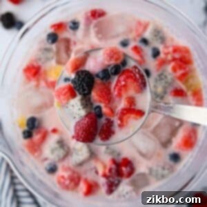 Hwachae: Korea's Vibrant Fruit Refreshment 9 A bowl of fruit and milky liquid, with a ladle taking a portion from the middle.