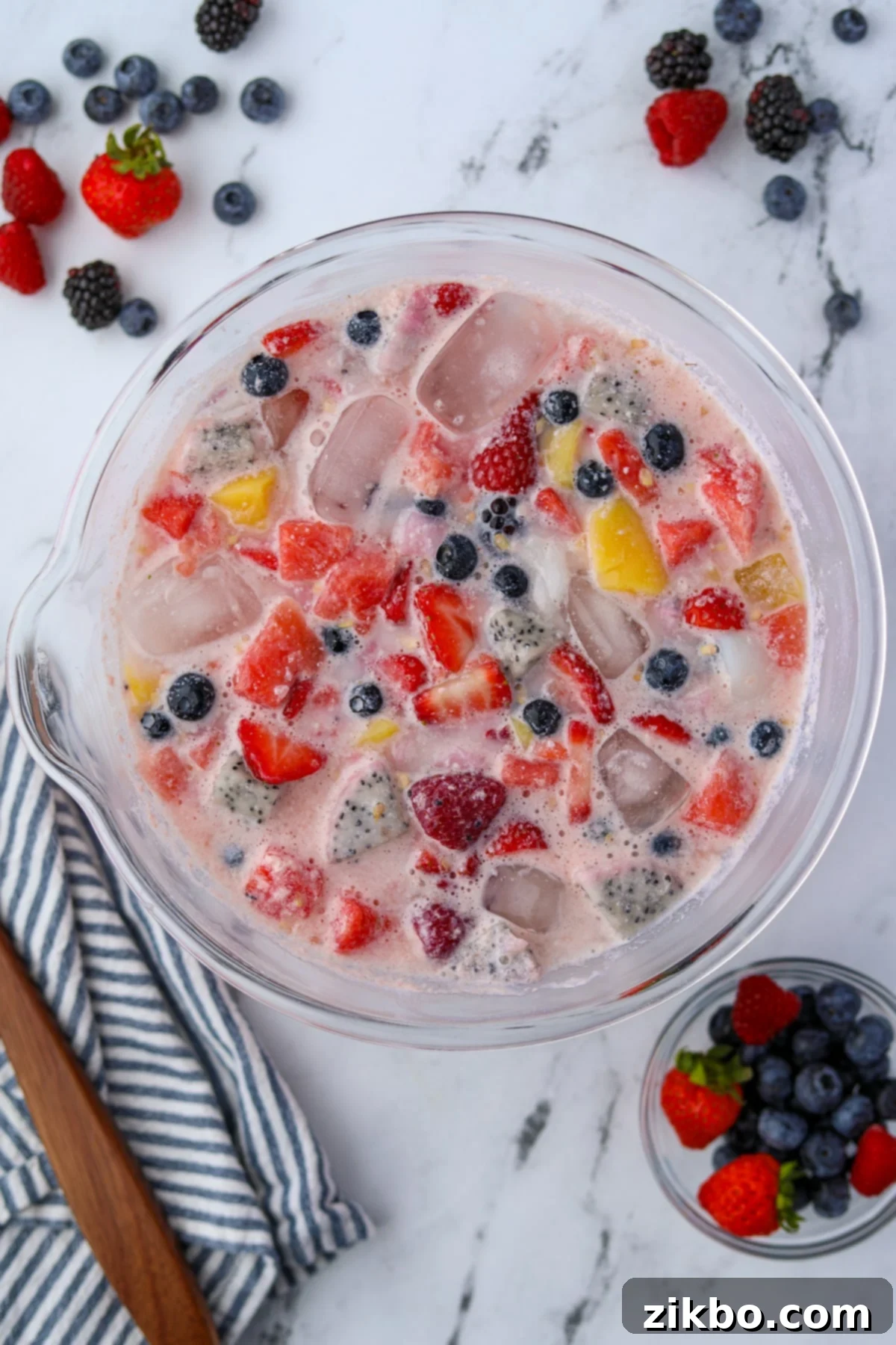 Hwachae: Korea's Vibrant Fruit Refreshment 5 A large bowl of fruit punch in a milky liquid.