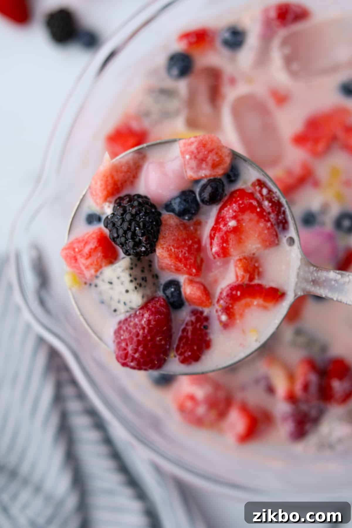 Hwachae: Korea's Vibrant Fruit Refreshment 6 A ladle full of berry and watermelon punch.