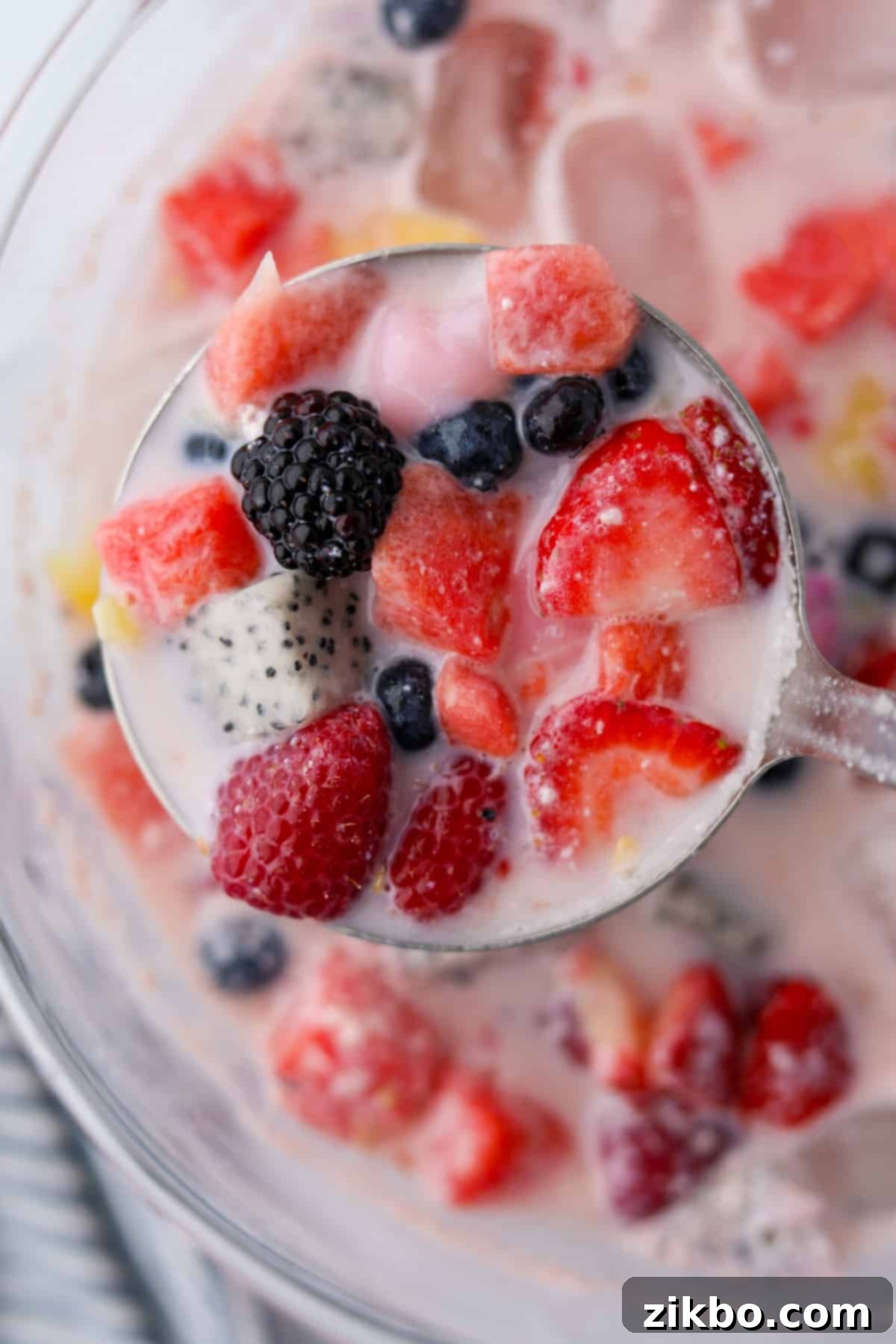 Hwachae: Korea's Vibrant Fruit Refreshment 8 A ladle filled with fruit and milk.