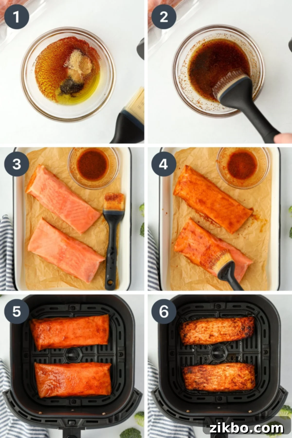 Brushing a seasoned oil on top of frozen salmon fillets, then placing them carefully into an air fryer basket.