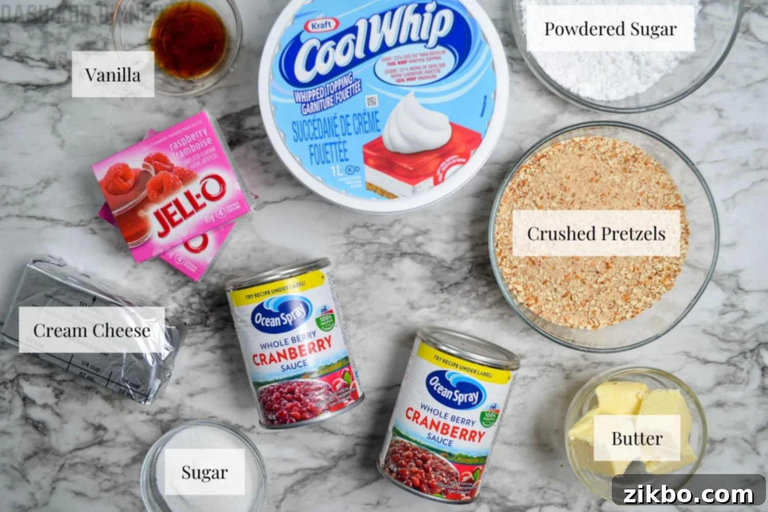 The ingredients needed to make cranberry pretzel salad dessert laid out on a table.