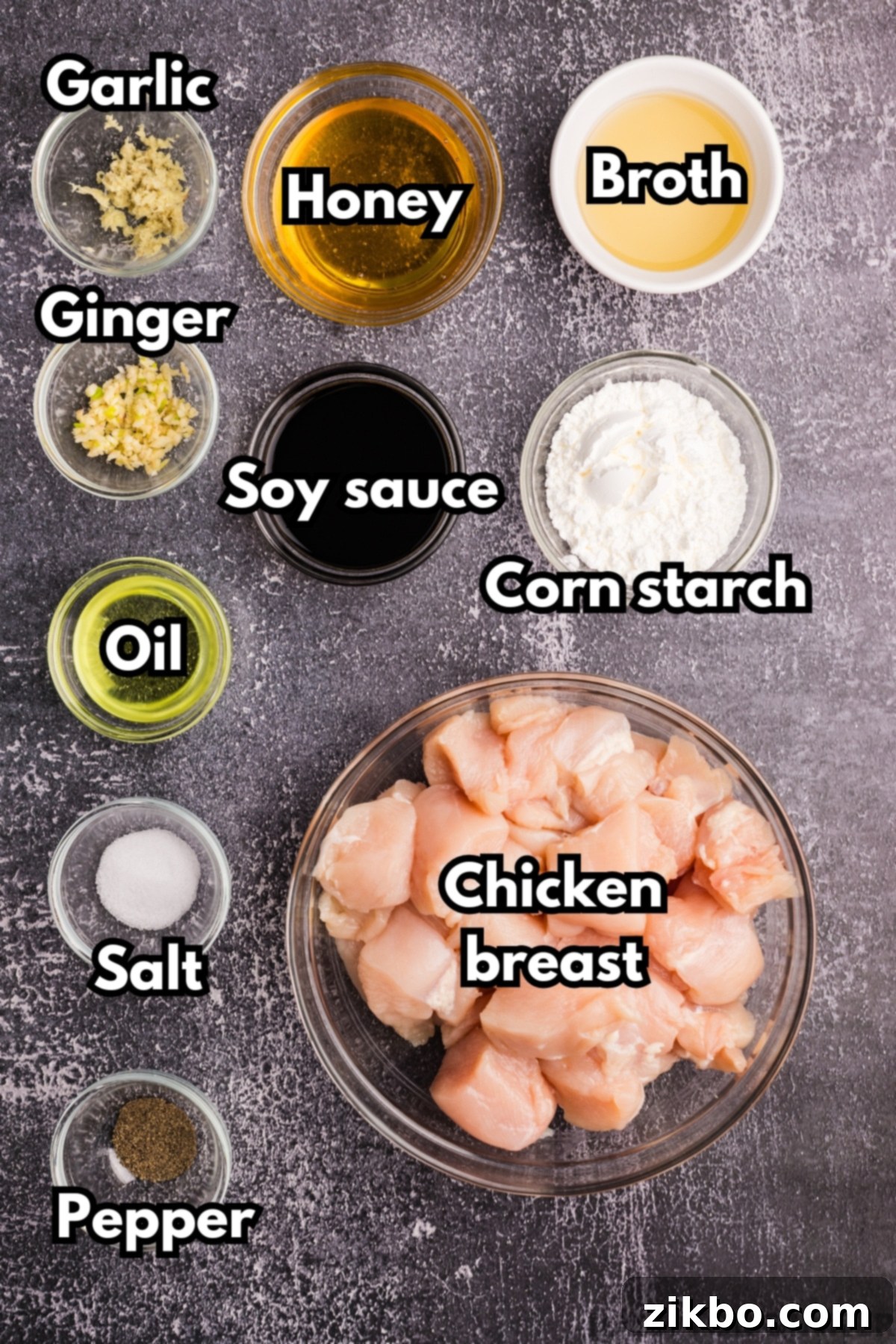 The ingredients needed to make honey ginger chicken, including soy sauce, cornstarch, cubed chicken breast, and ginger. 