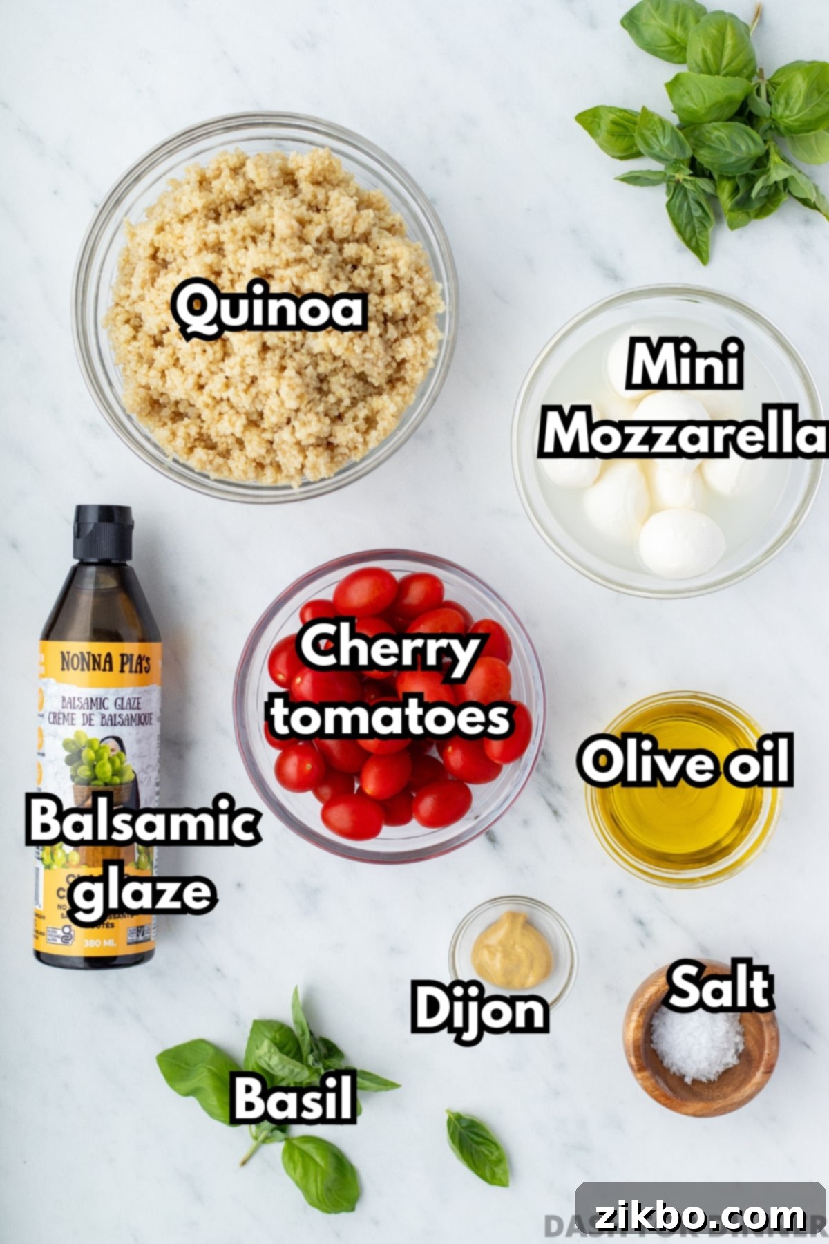 Fresh Caprese Quinoa 3 The ingredients needed to make caprese quinoa salad, including cherry tomatoes, basil, and olive oil.