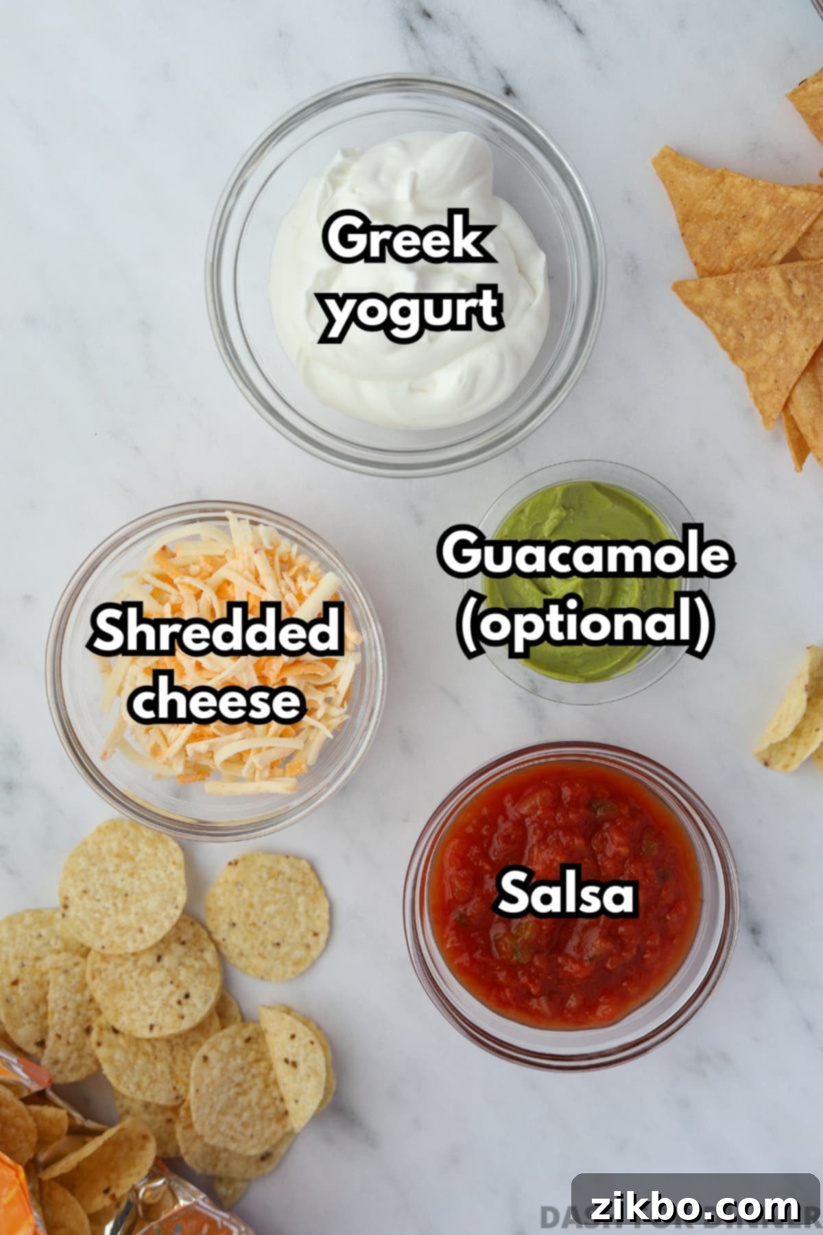 The ingredients needed to make layered protein dip: Greek yogurt, salsa, shredded cheese, and guacamole.
