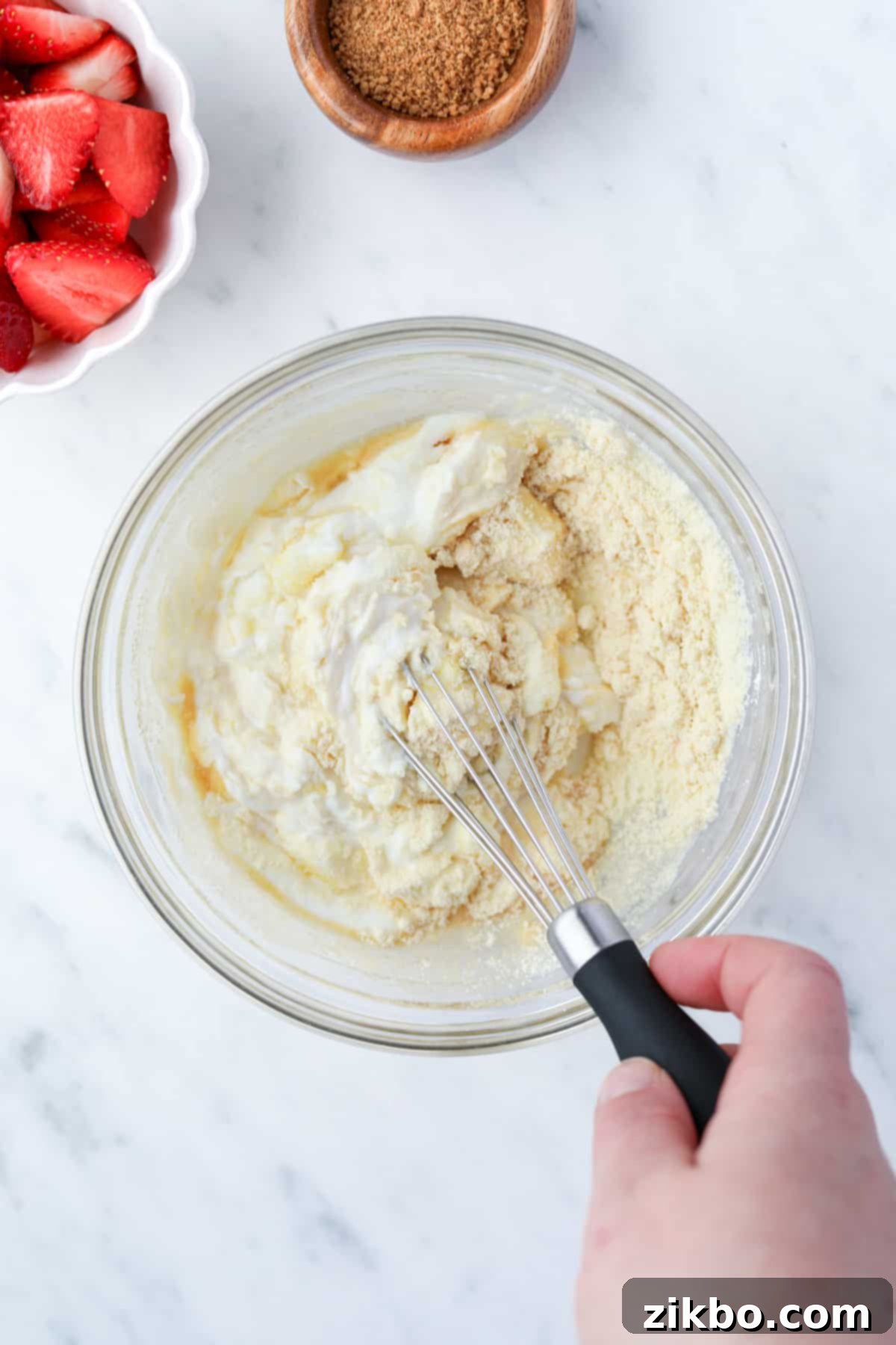 Whisking together a bowl of yogurt with other ingredients.