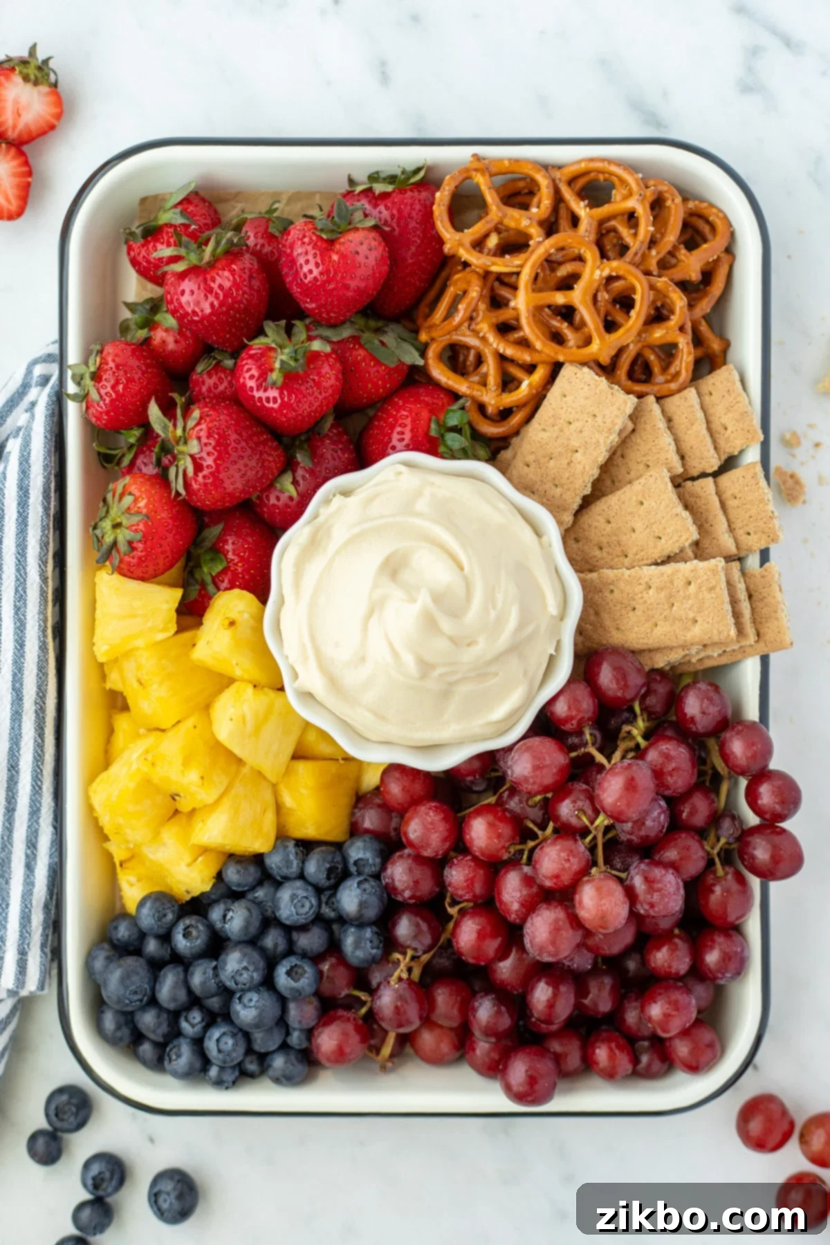 Decadent Sweet Cream Cheese Dip 5 A fruit tray with cream cheese dip in the center.