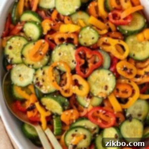Fresh Cucumber & Bell Pepper Salad 9 A bowl of sliced cucumber and sliced mini pepper tossed with dressing and a sprinkling of sesame seeds.