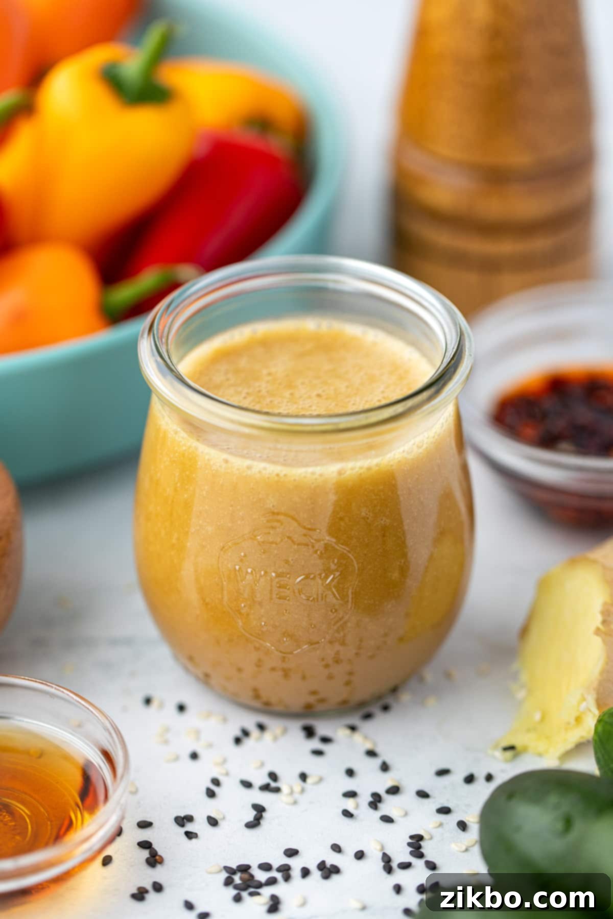 Sesame Ginger Dressing 2 A small glass jar filled with freshly made homemade sesame ginger dressing, ready to be served.
