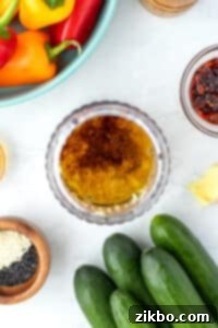 A mini blender cup filled with all the liquid and grated ingredients, ready for blending into a flavorful vinaigrette.