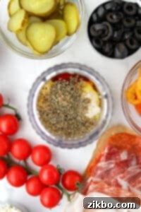 A small jar blender filled with olive oil, oregano, red wine vinegar, etc.