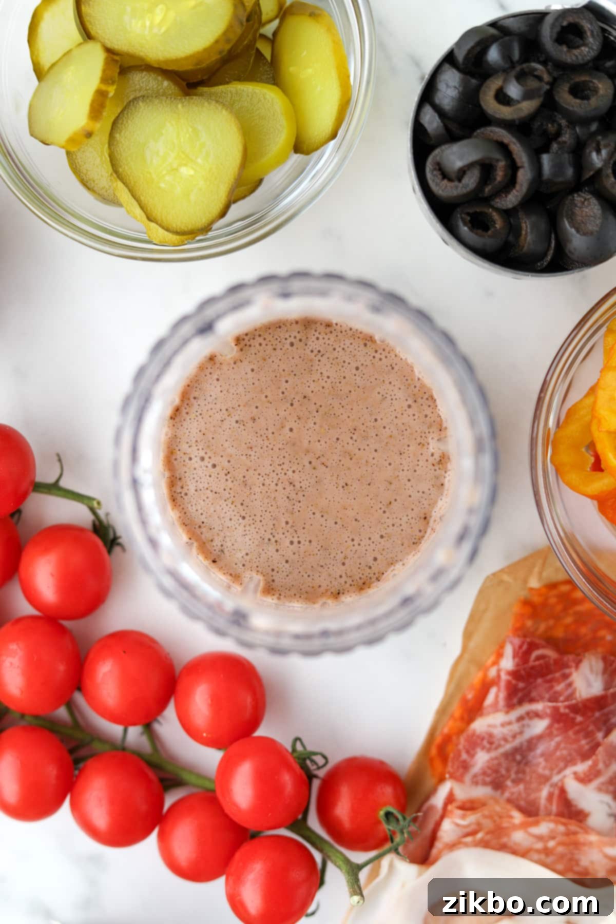 A small jar blender filled with creamy, perfectly emulsified Italian sub dressing, showcasing its smooth and inviting consistency.