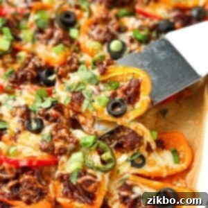 Lifting mini pepper nachos from a sheet pan.