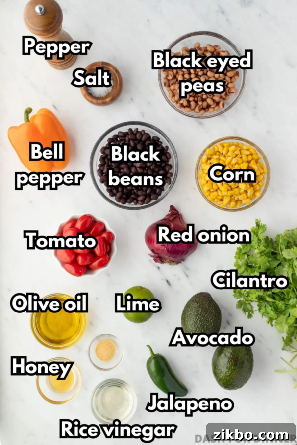 The ingredients needed to make cowboy caviar, including black beans, black eyed peas, corn, and fresh cilantro, laid out on a table.