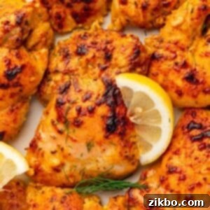 Delicious Greek Yogurt Chicken 12 Seasoned and chicken thighs garnished wtih lemon wedges and fresh dill.