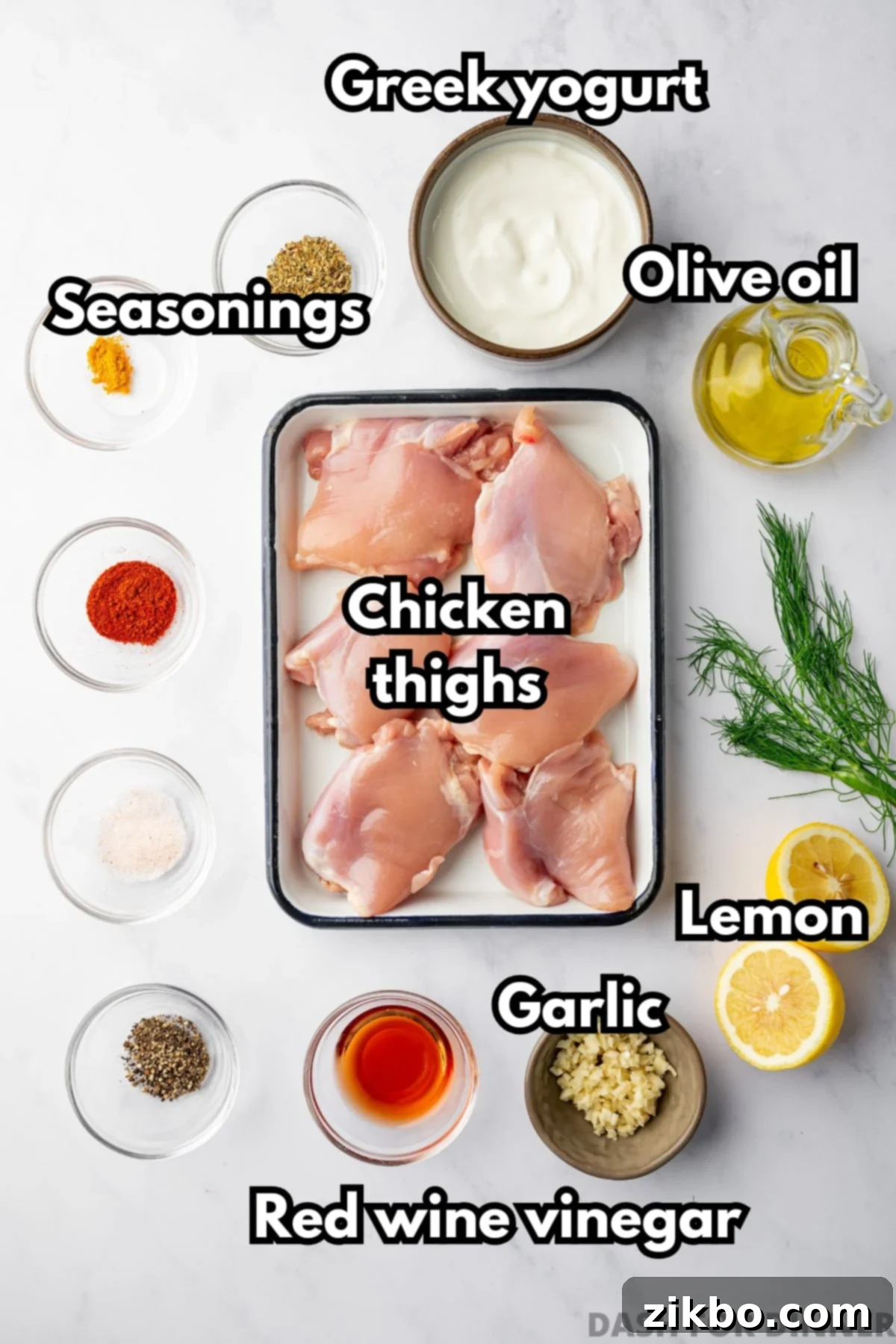 Delicious Greek Yogurt Chicken 3 The ingredients needed to make greek yogurt chicken, including seasonings, lemon, garlic, and chicken thighs.