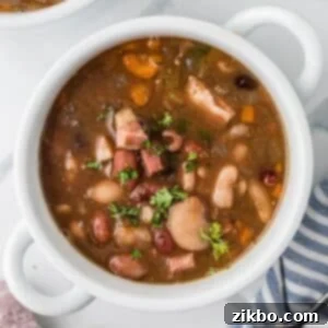15 Bean Soup 9 A bowl of soup filled with juicy beans and ham chunks.