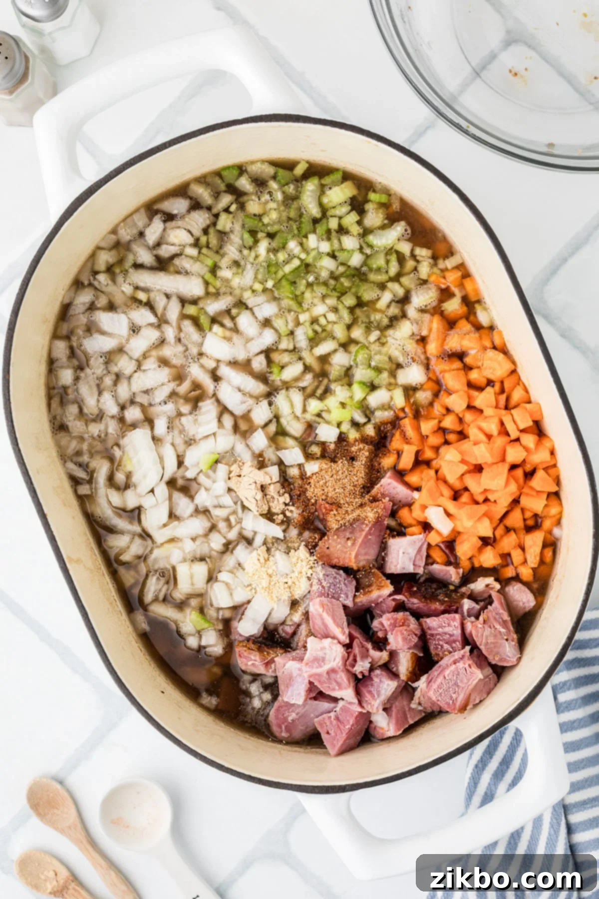 15 Bean Soup 5 Chopped vegetables and ham floating in the bean soup broth.