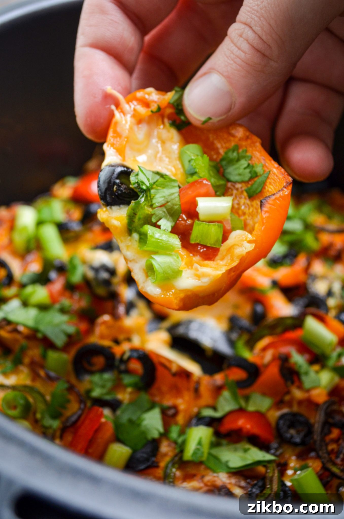 Vibrant Air Fryer Mini Pepper Nachos topped with cheese and fresh toppings, ready to eat.