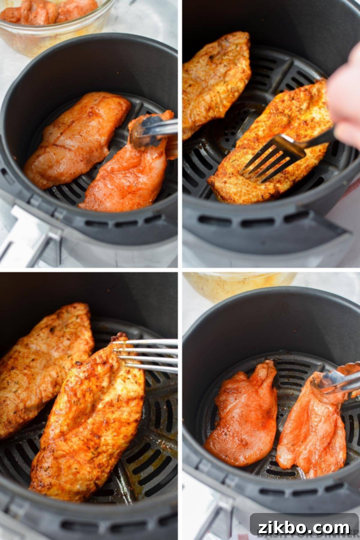 Several seasoned chicken breast cutlets are perfectly arranged in a single layer inside an air fryer basket, with sufficient space between each for even cooking and crisping.