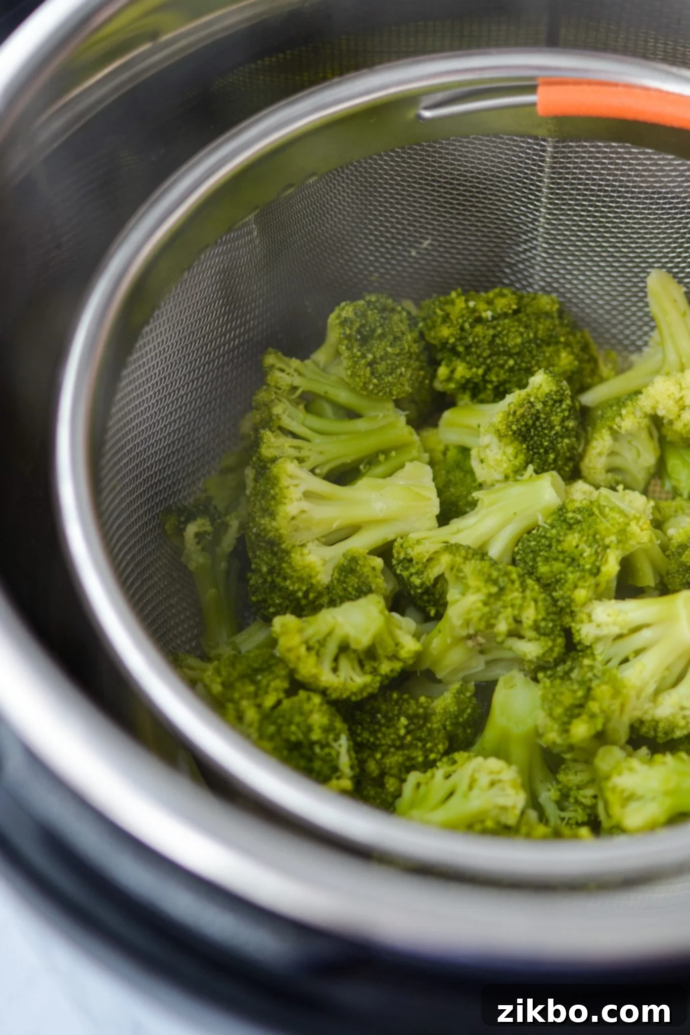Cooked broccoli inside a steamer basket in the Instant Pot.