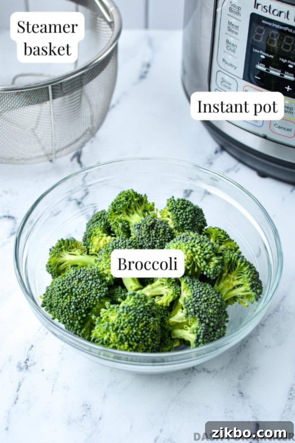A bowl of fresh broccoli with a steamer basket and an Instant Pot in the background, showcasing the essential tools.