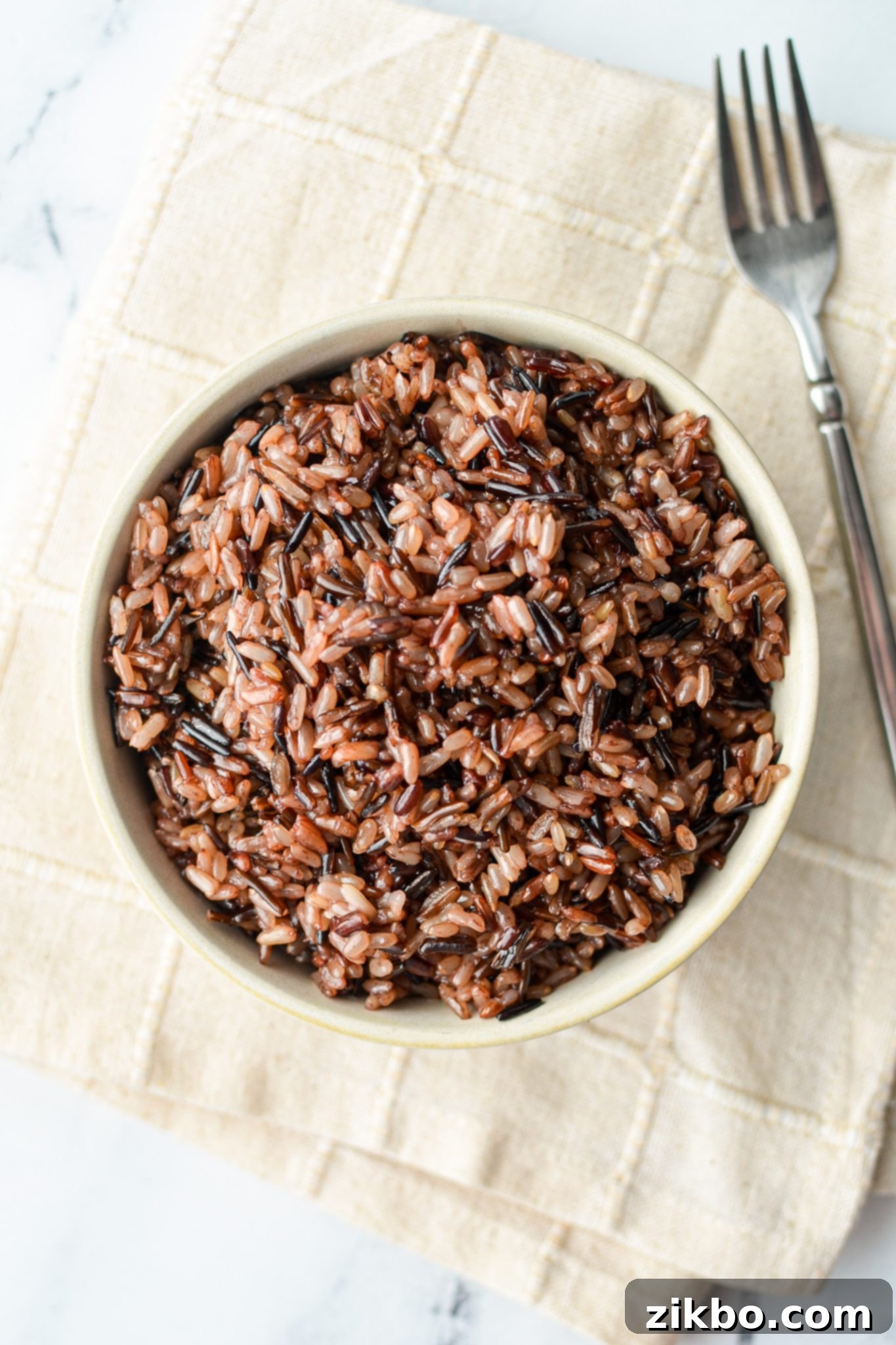 A delicious bowl of wild rice blend, perfectly cooked and presented on an off-white cloth, inviting you to savor its wholesome goodness.