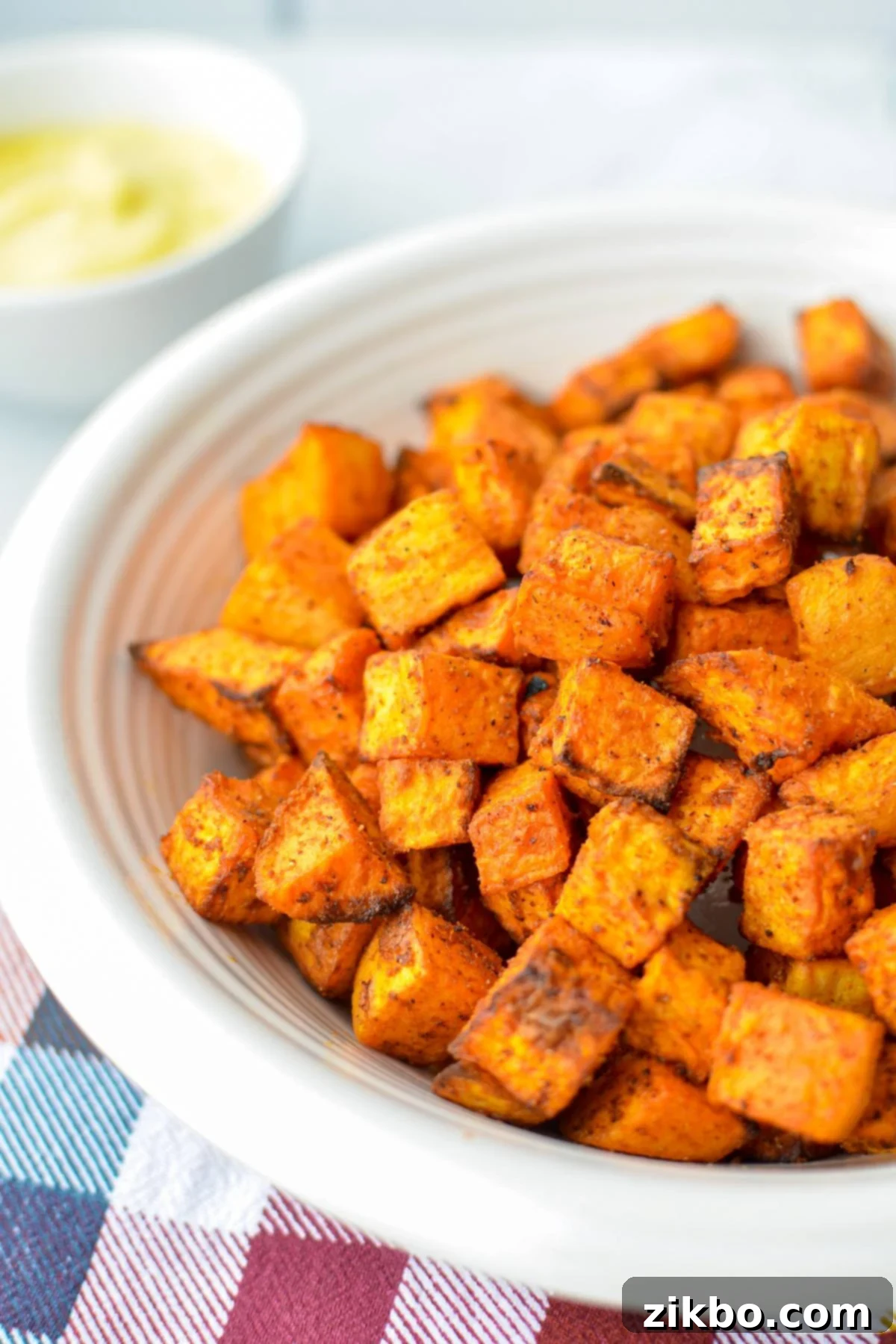 Crispy Air Fryer Sweet Potato Cubes 2 A bowl of golden, crispy air fried sweet potato cubes, perfectly seasoned and ready to serve.