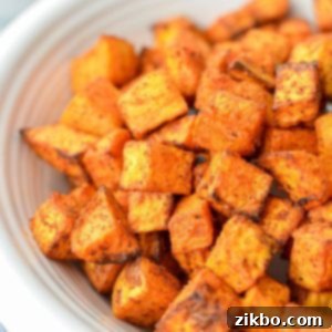 Crispy Air Fryer Sweet Potato Cubes 11 A close up of sweet potato cubes that have been roasted to a golden, crispy perfection in an air fryer.