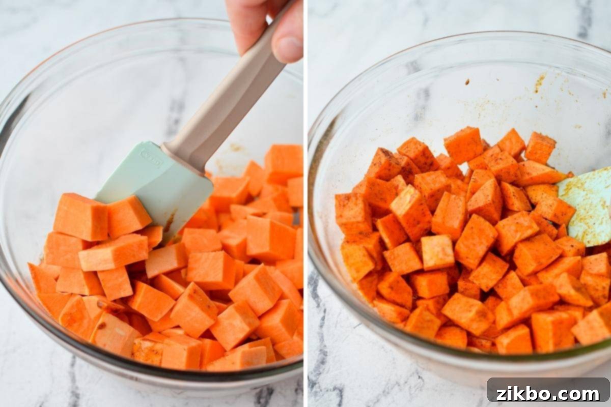 Crispy Air Fryer Sweet Potato Cubes 6 A person tossing cubed sweet potatoes with seasoned oil in a mixing bowl, ensuring an even coating.