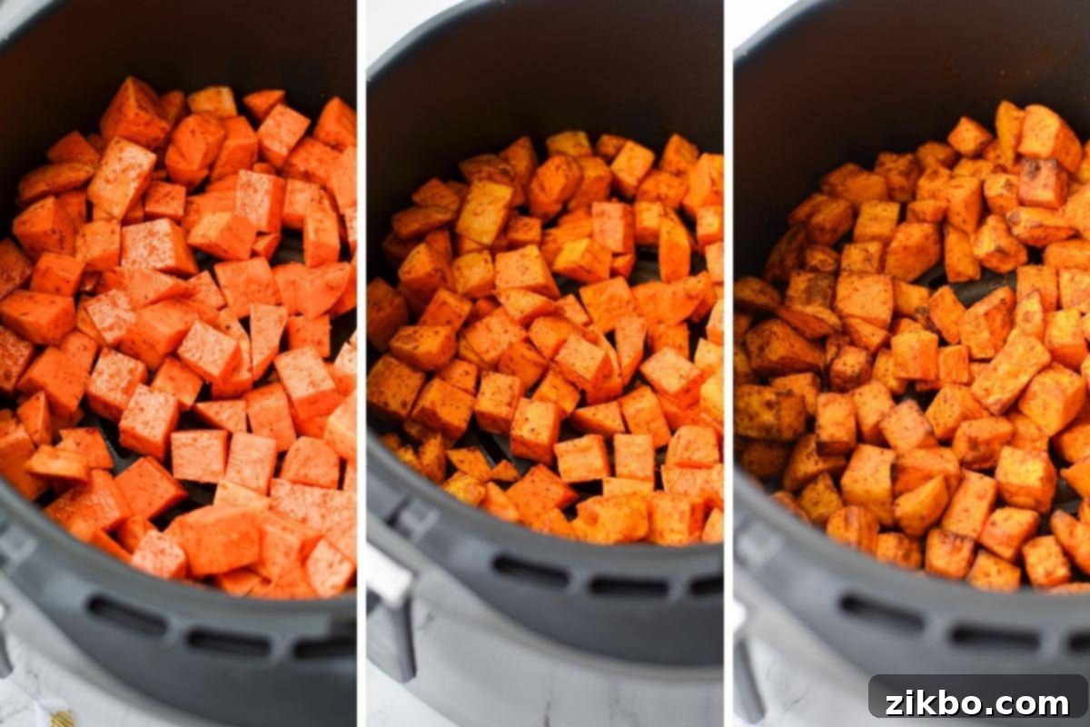 Crispy Air Fryer Sweet Potato Cubes 7 An air fryer basket showcasing sweet potato cubes at different stages: raw, partially cooked, and fully roasted to a golden crisp.