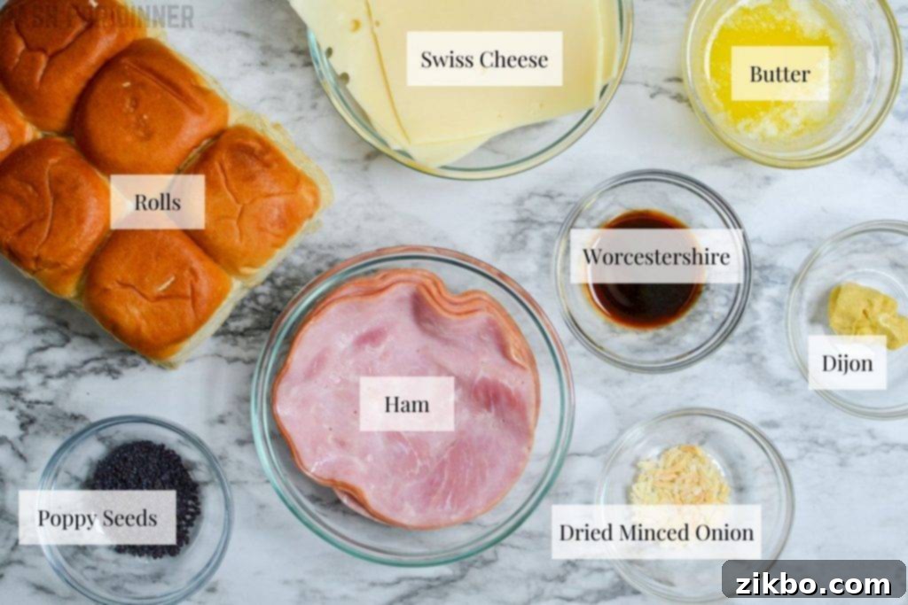 Golden Air Fryer Ham and Cheese Sliders 3 Various ingredients for ham and cheese sliders laid out on a table, including rolls, ham, cheese, and sauce components.