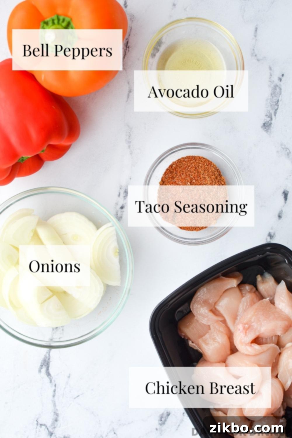 Crispy Air Fryer Chicken Fajitas 3 Fresh ingredients laid out: sliced chicken breast, colorful bell peppers, and an onion, ready for Air Fryer Chicken Fajitas.