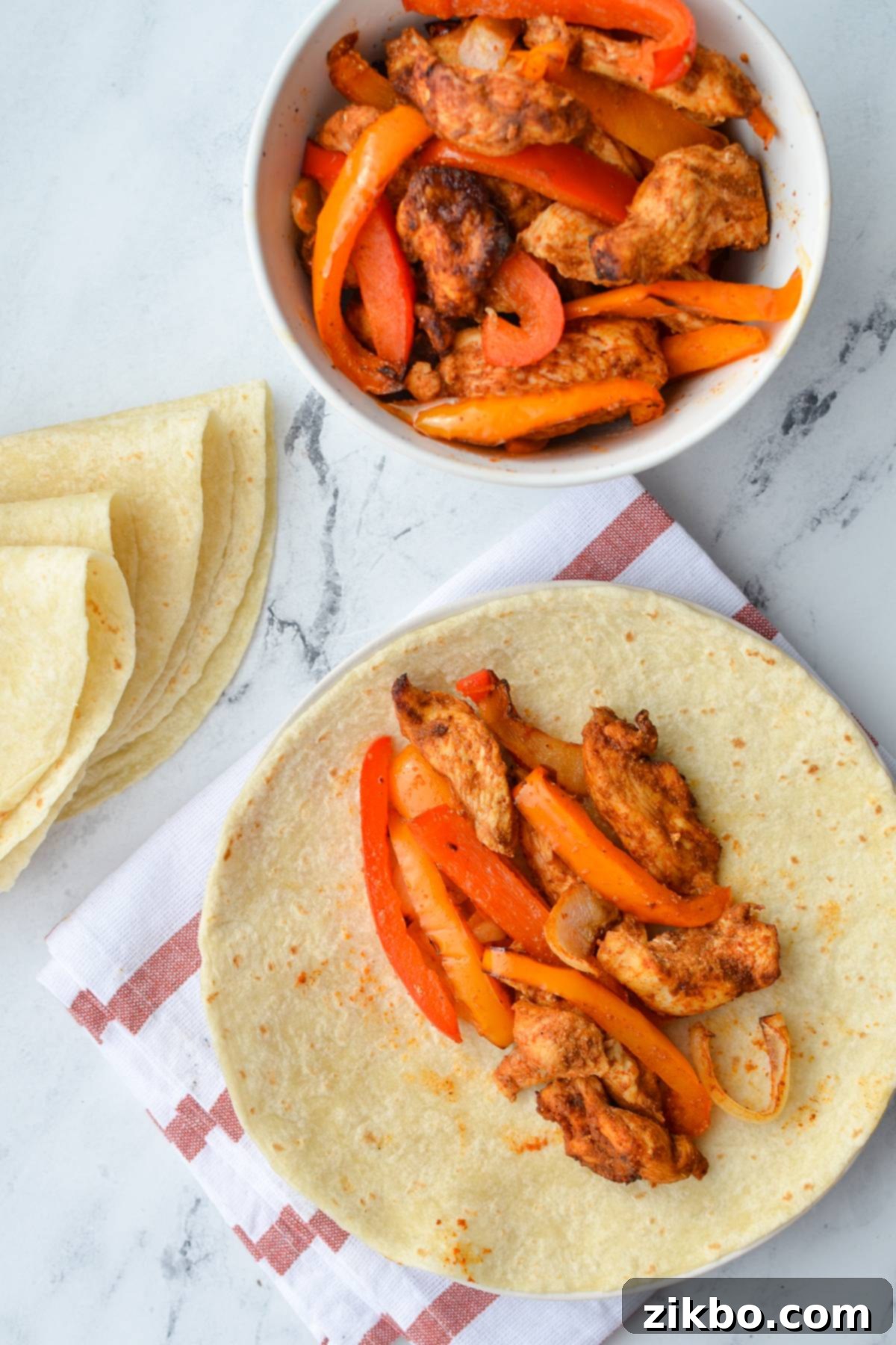 Crispy Air Fryer Chicken Fajitas 8 A soft flour tortilla generously filled with delicious air fryer chicken fajita mix, showcasing the colorful ingredients.