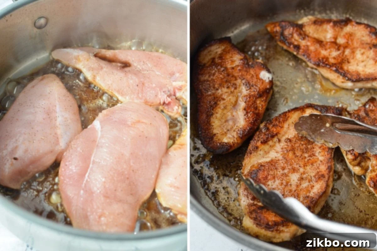 Chicken cutlets searing to a golden brown in a hot skillet with melted butter.