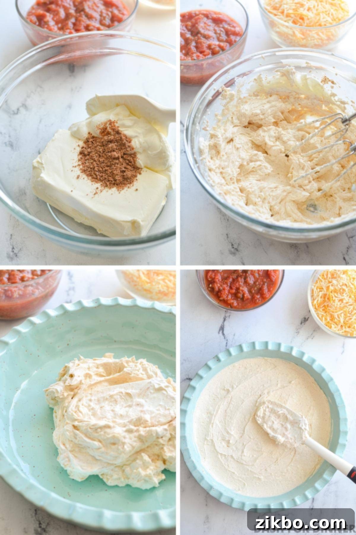 A close-up view of the smooth, creamy seasoned cream cheese and sour cream mixture being evenly spread into a 9-inch baking dish, forming the foundational layer of the dip.